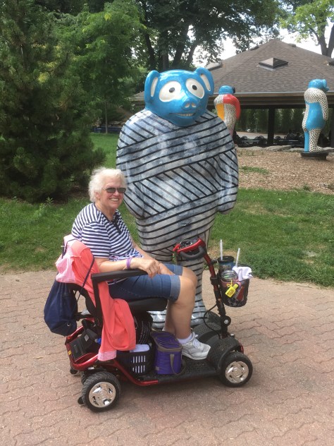 Mom with the whimsical statue she liked at Omaha Zoo